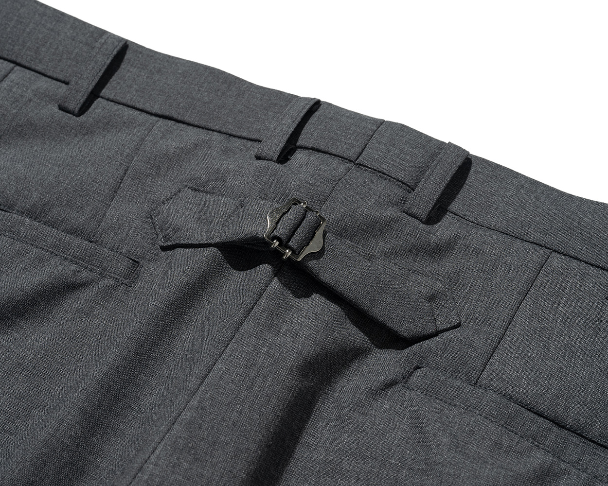 Cinch back detail on Renacts pipe-stem trousers inspired by 1950s Ivy League style