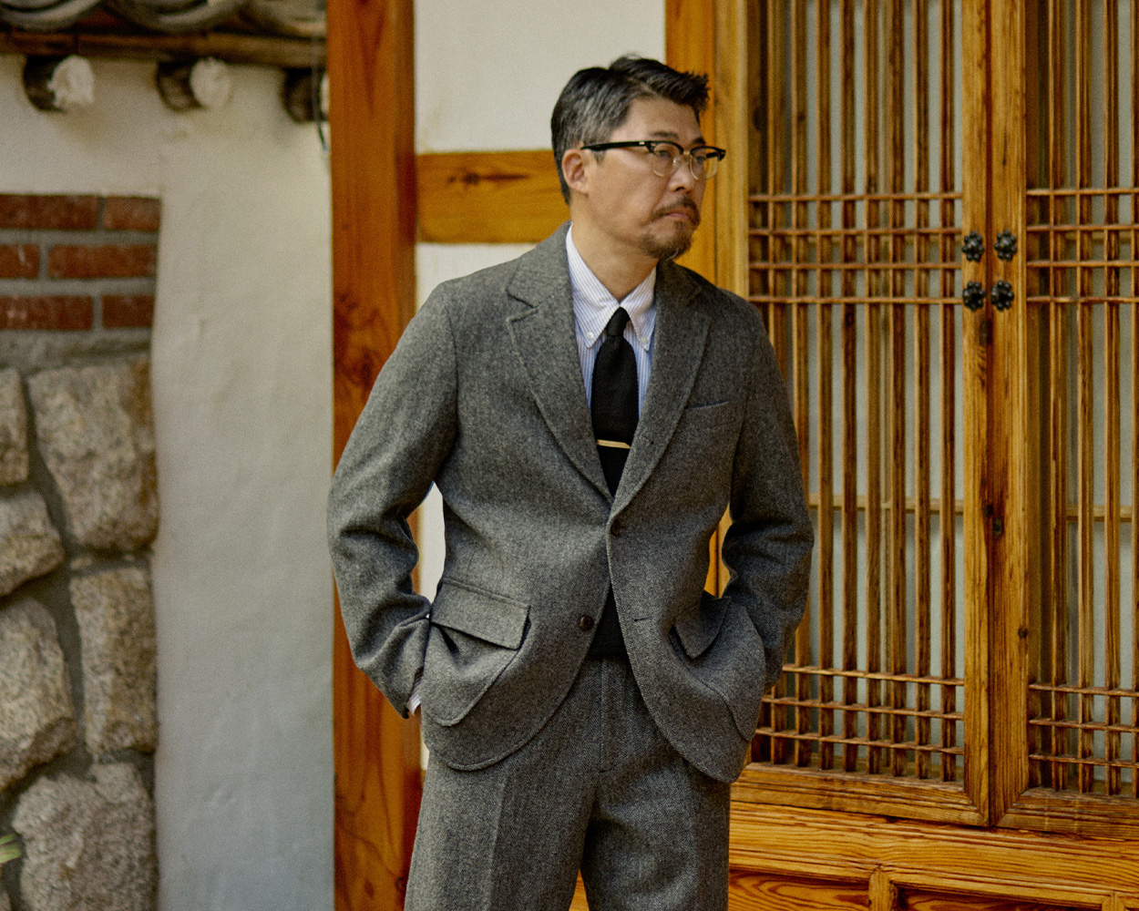Renacts grey sack suit embodying modern Seoul Trad Style and Ivy heritage
