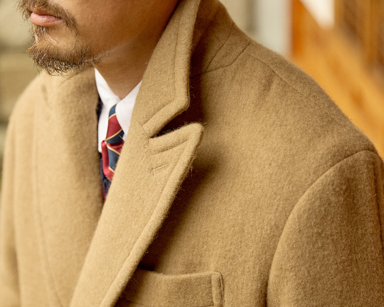Renacts polo coat fabric detail showing 40% camel and 60% wool blend for warmth and durability