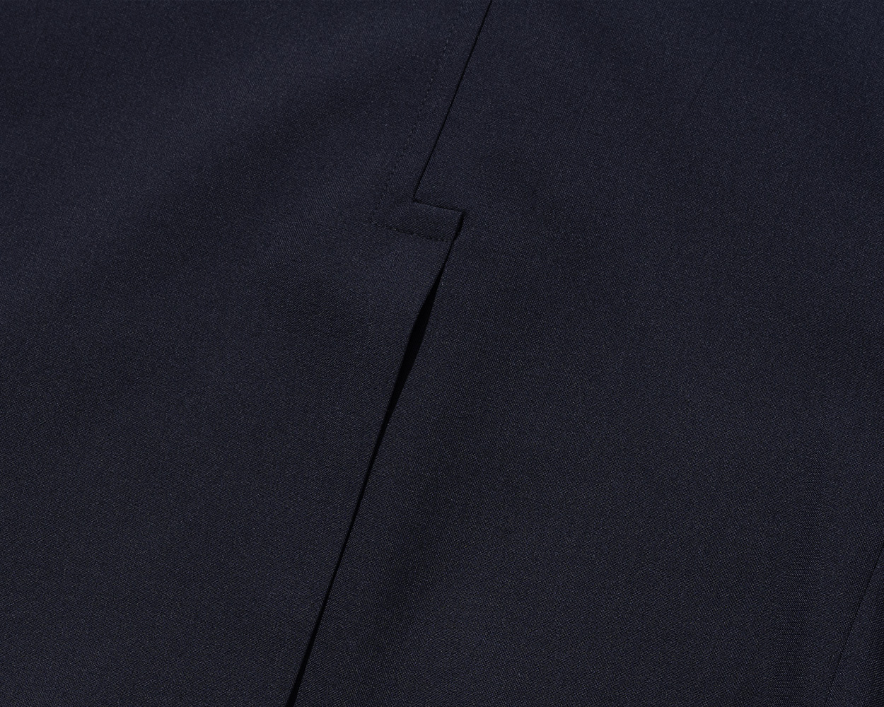 Hook vent detail on the back of a Renacts navy blazer
