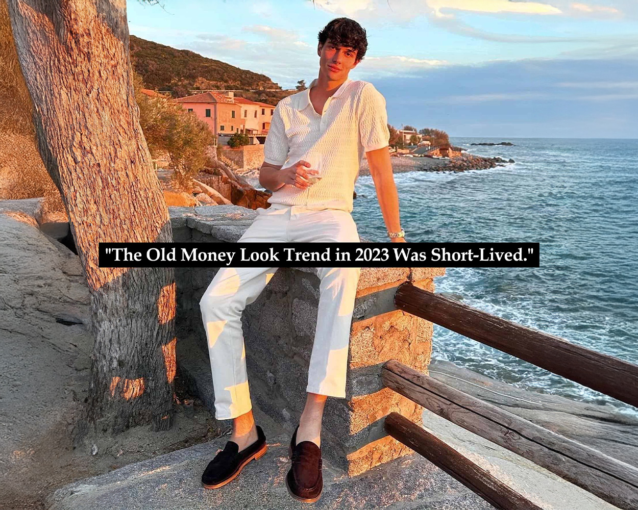 a man sit on the fence with ivory shirt and white pants