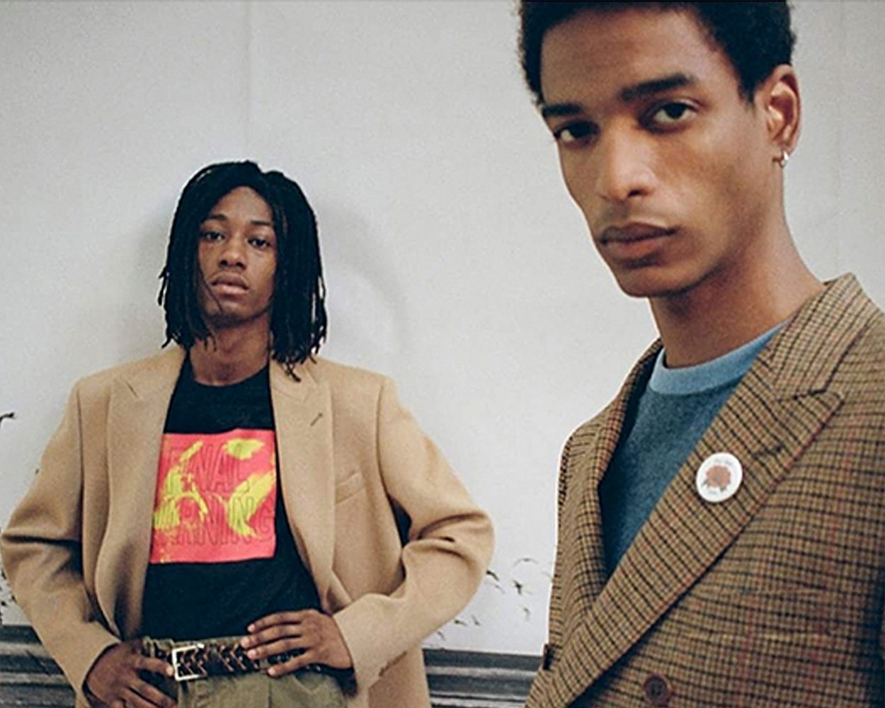 two men keep on their eyes on camera