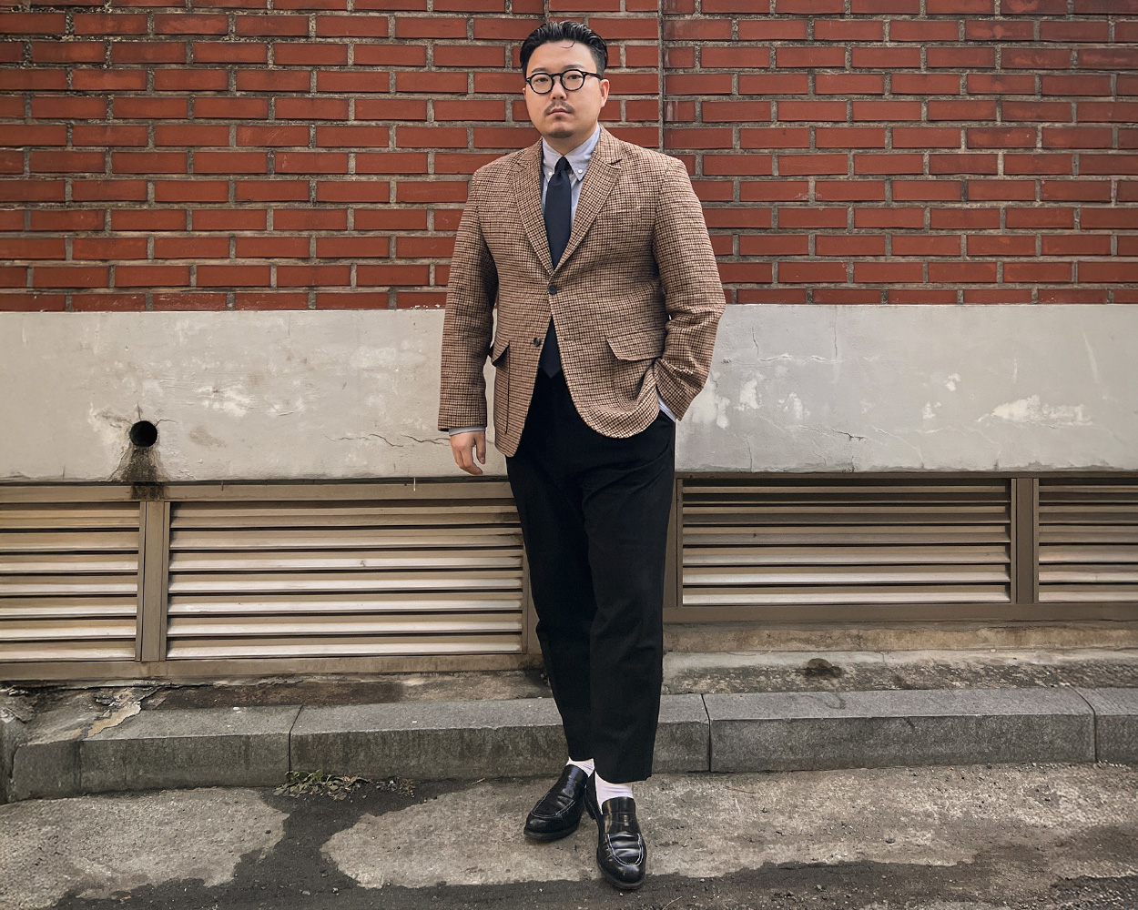 Gun Club jacket paired with blue shirt, black tie and black trousers