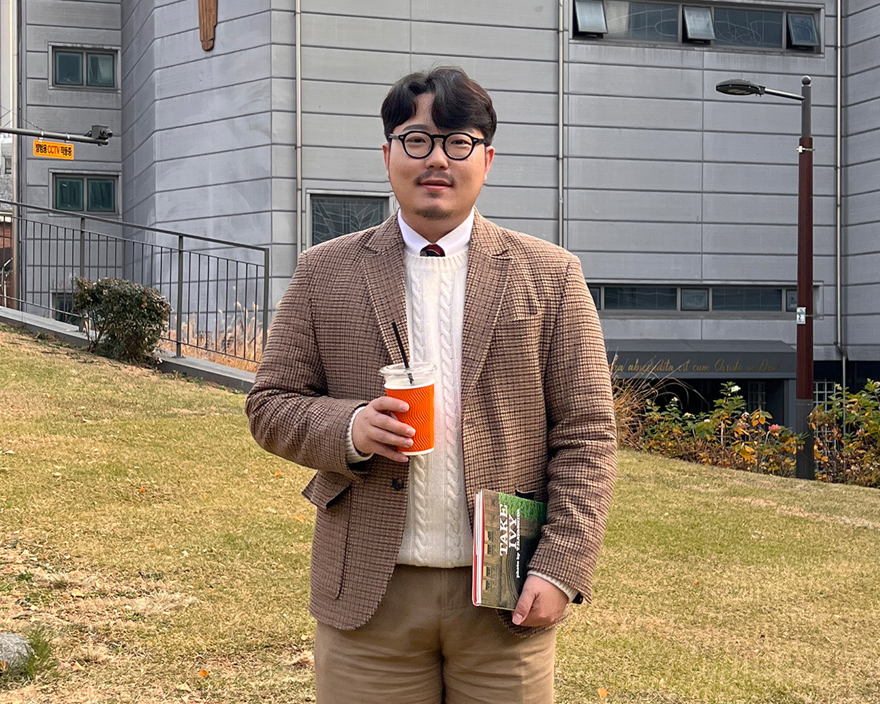 Cable knit sweater layered under a Gun Club check jacket