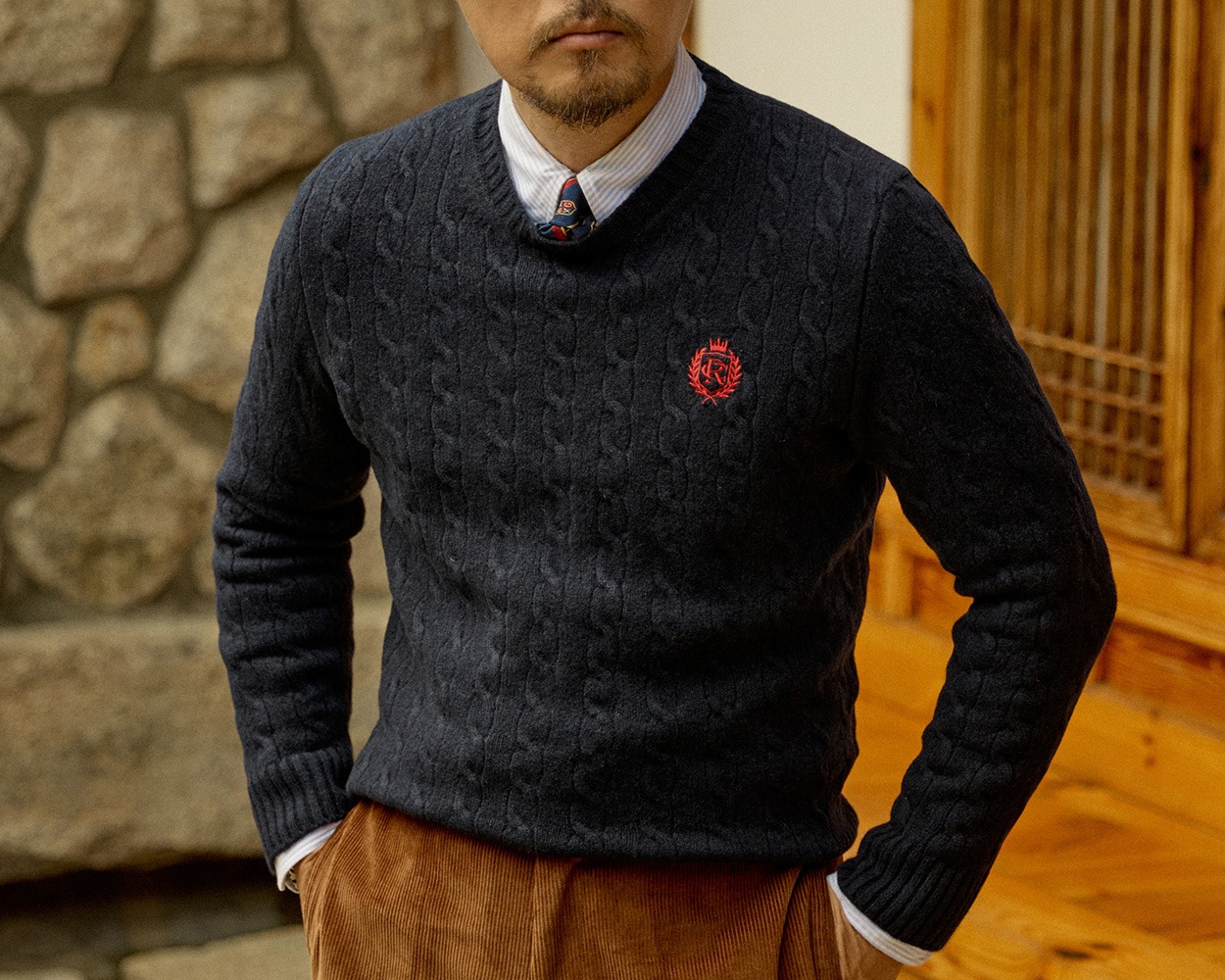 Renacts cable knit sweater showcasing refined Ivy craftsmanship