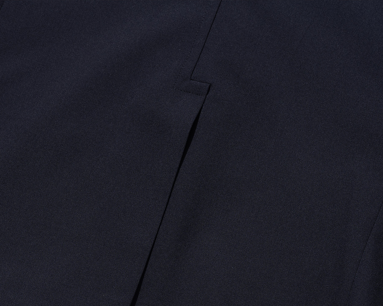 Close-up of navy blazer fabric highlighting timeless color and texture
