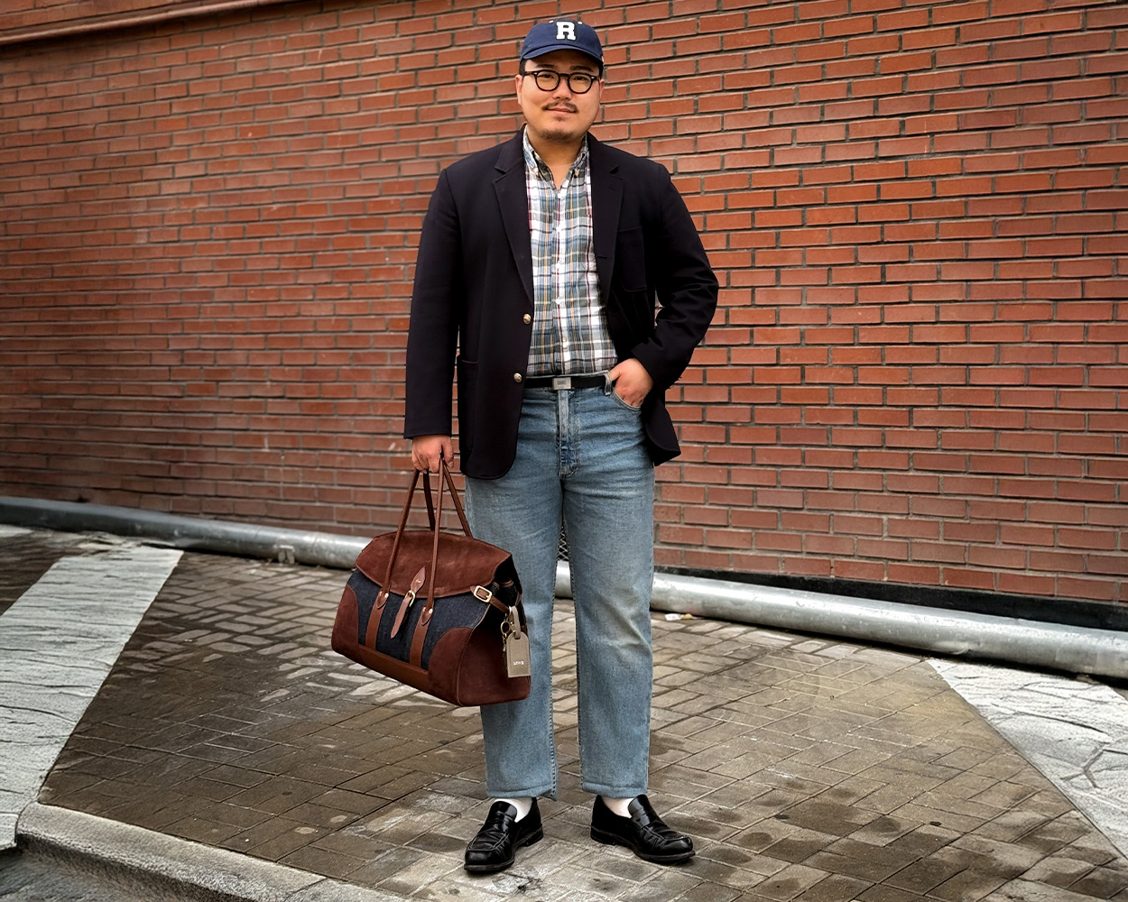Modern menswear outfit featuring a navy blazer in an urban setting