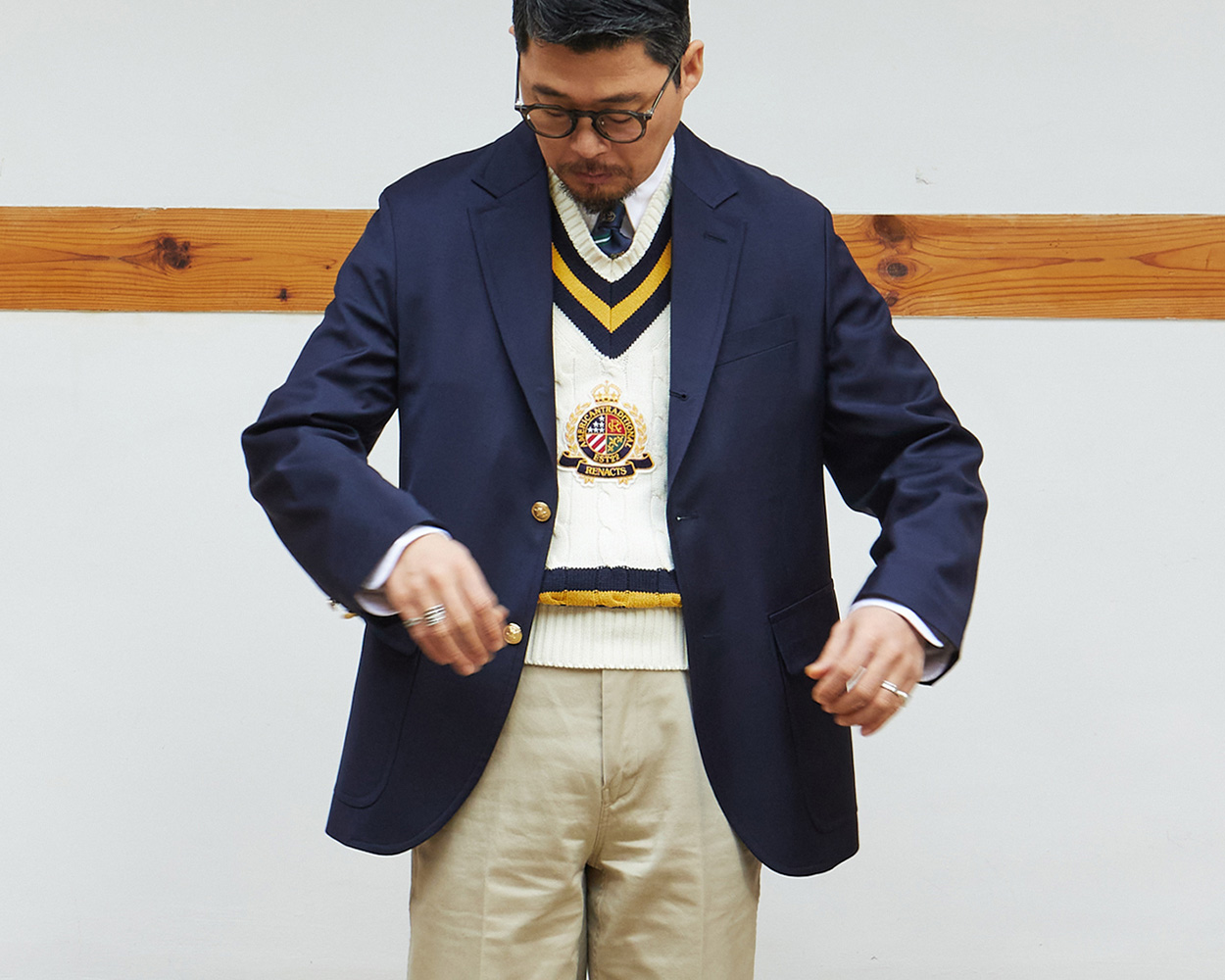 Renacts gold button navy blazer styled in modern Ivy menswear