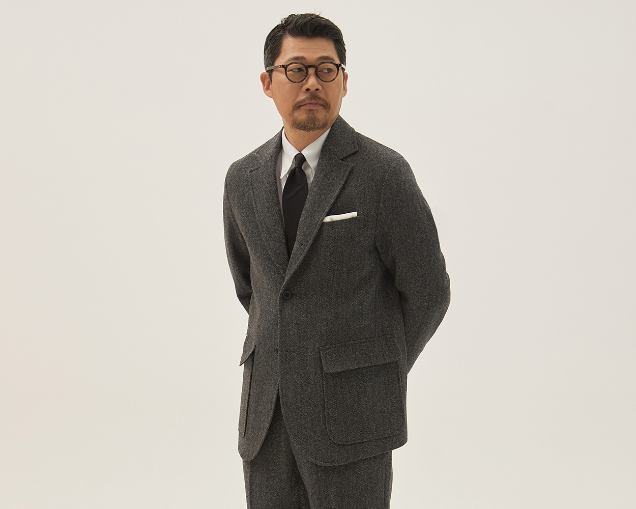 Herringbone tweed jacket showcasing its classic woven pattern and tailored silhouette