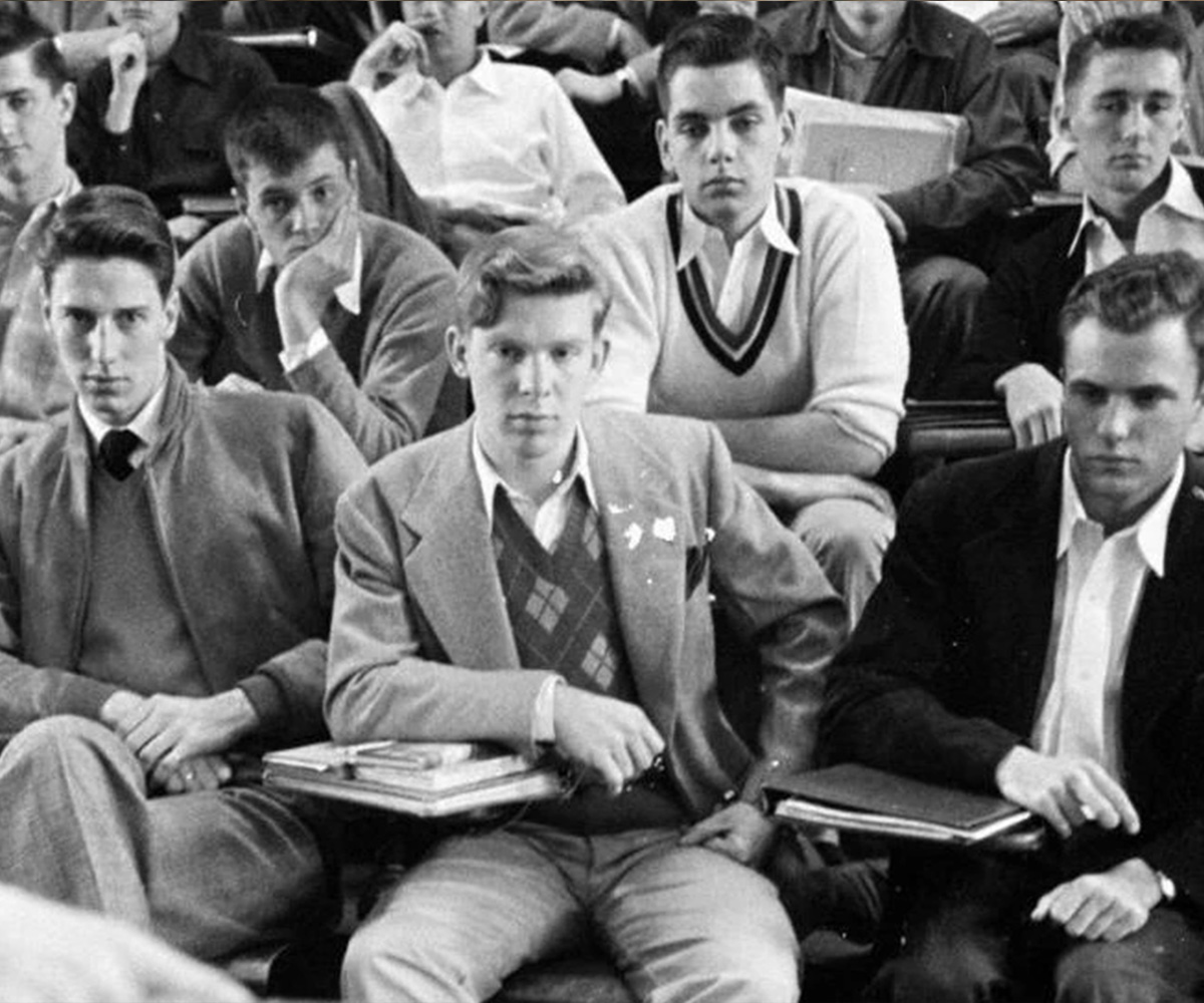 Students wearing sports coats while studying in an American university library during the 1950s.