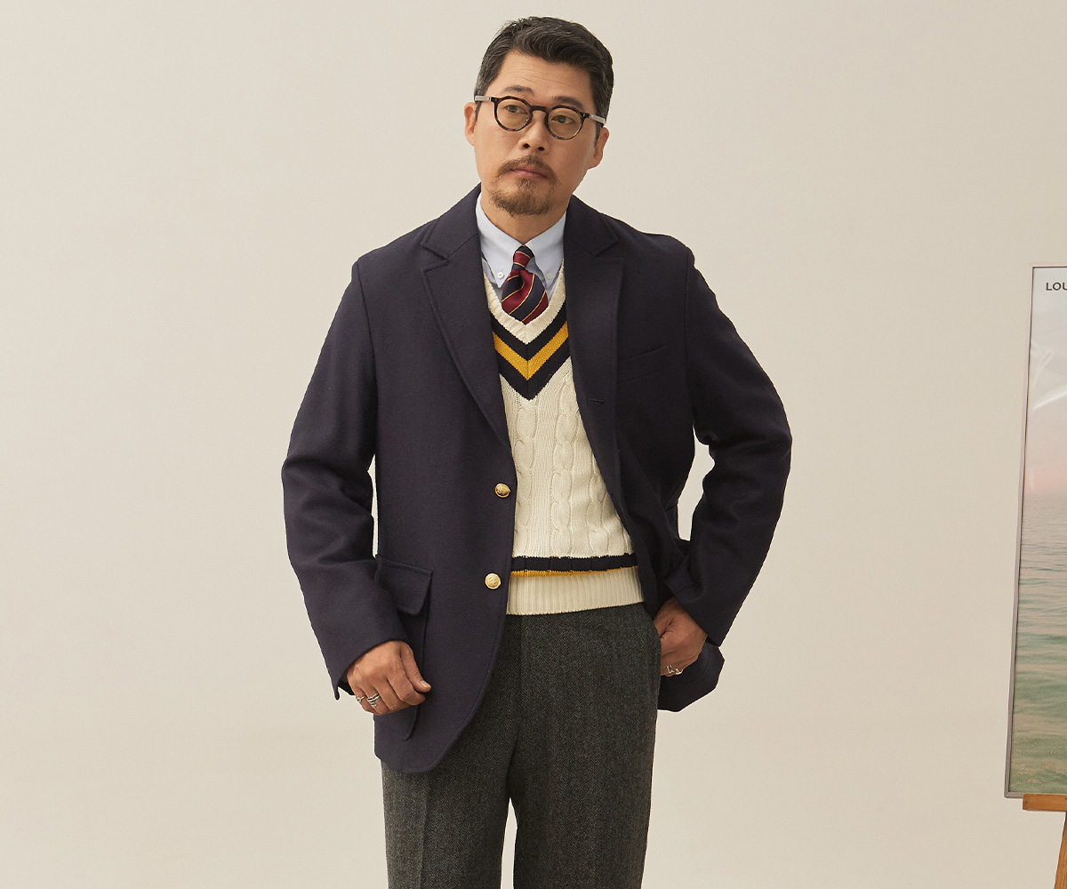 A full-body look of a male model stylishly matching a different colored jacket and trousers.