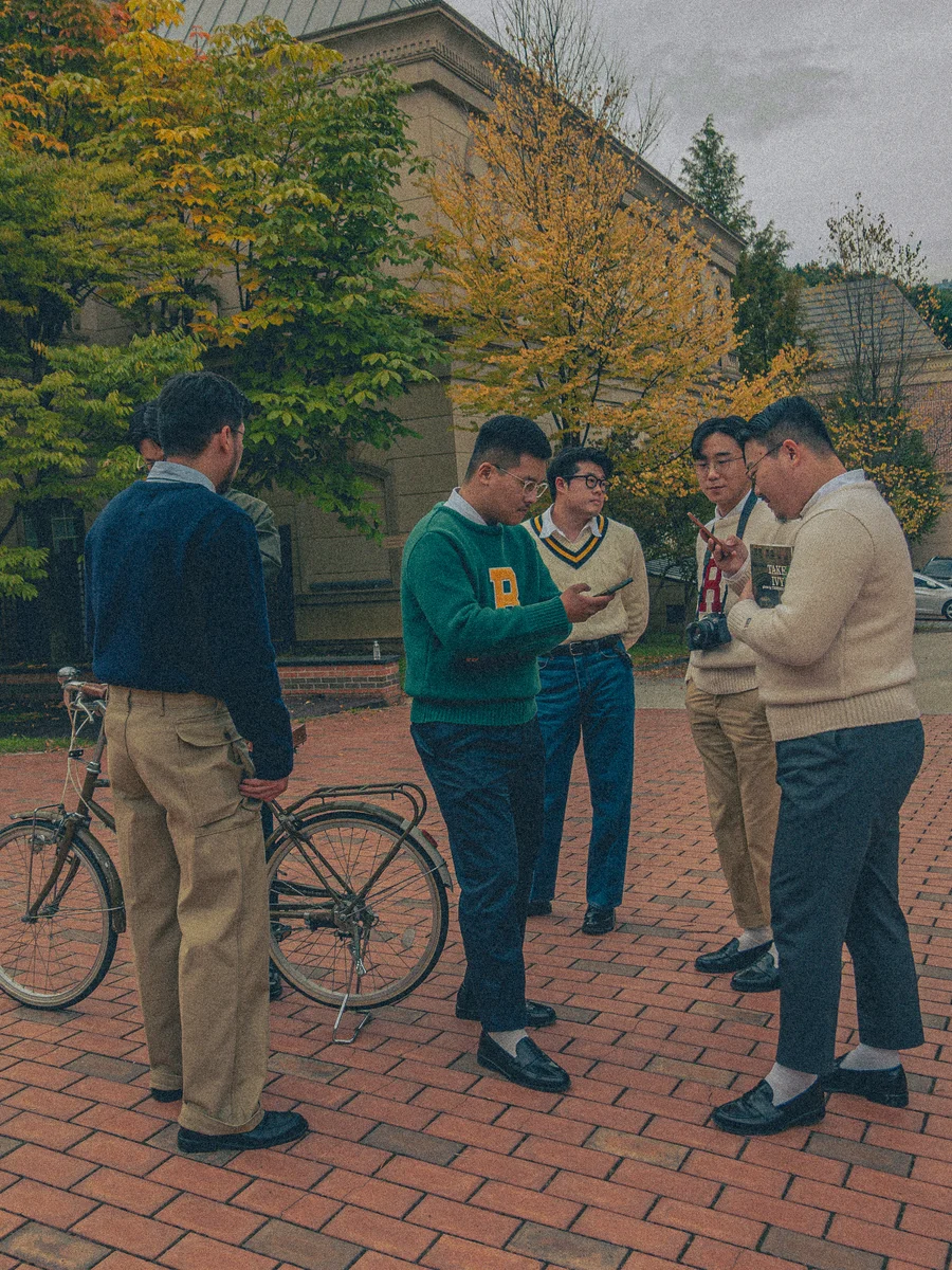 Five crewneck sweater outfits for men — campus classic, muted Seoul, blazer layer, weekend anorak, tie included