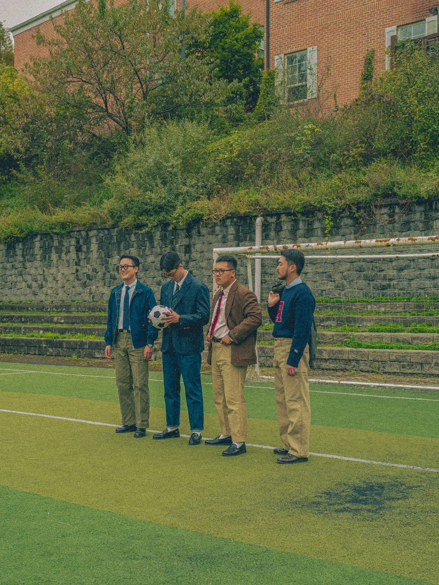 Ivy League students wearing khaki chinos with crewneck sweaters on campus, circa 1960s