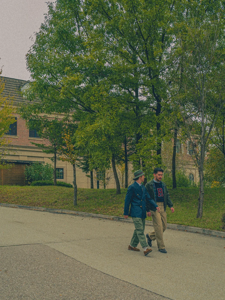 A student in penny loafers and chinos from a 1960s campus photograph, showing the effortless Ivy League look