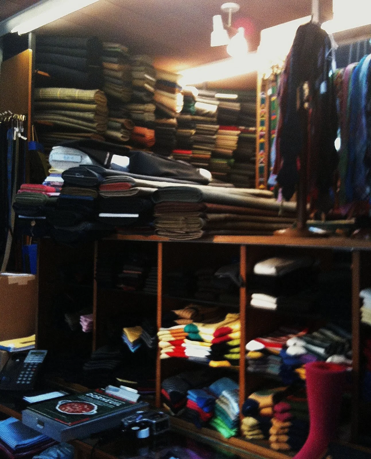 Andover Shop history: interior view of the Cambridge store showing tweed jackets, knitwear, and the dense merchandise layout that defined the shop