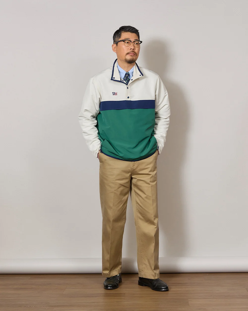 Anorak outfit men spring — Renacts anorak over OCBD with tie, chinos and Alden penny loafers, the dressed-up Ivy move