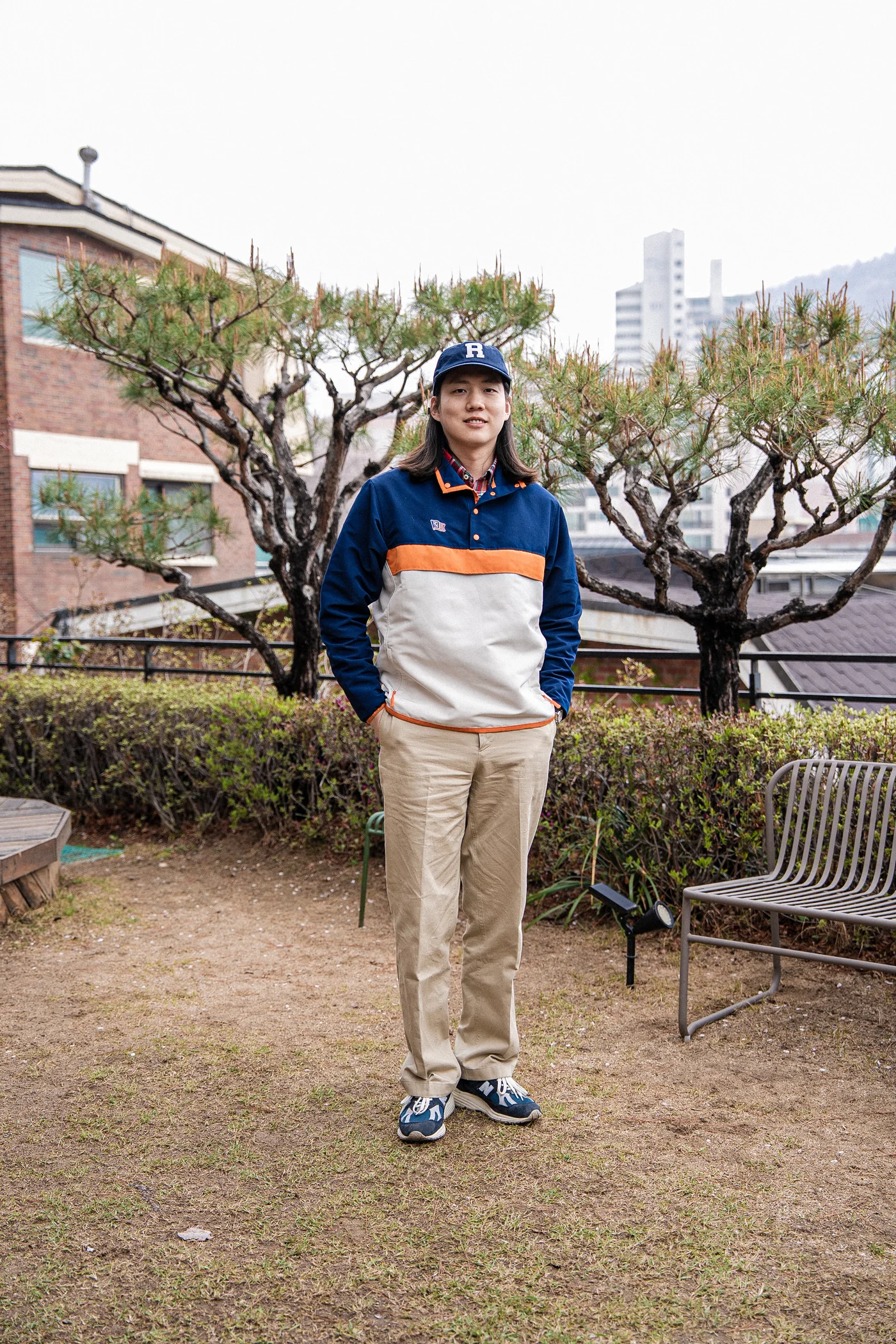 Anorak outfit men spring — Renacts anorak over madras with chinos and New Balance 991v2, the everyday Seoul pairing