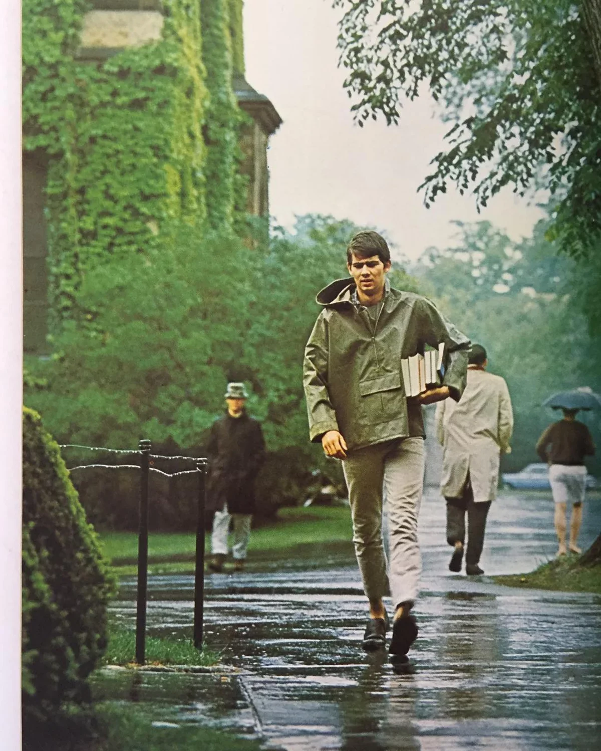 Anorak jacket history — 1965 Take Ivy photograph of a Princeton student in a pullover anorak walking in the rain with books and loafers