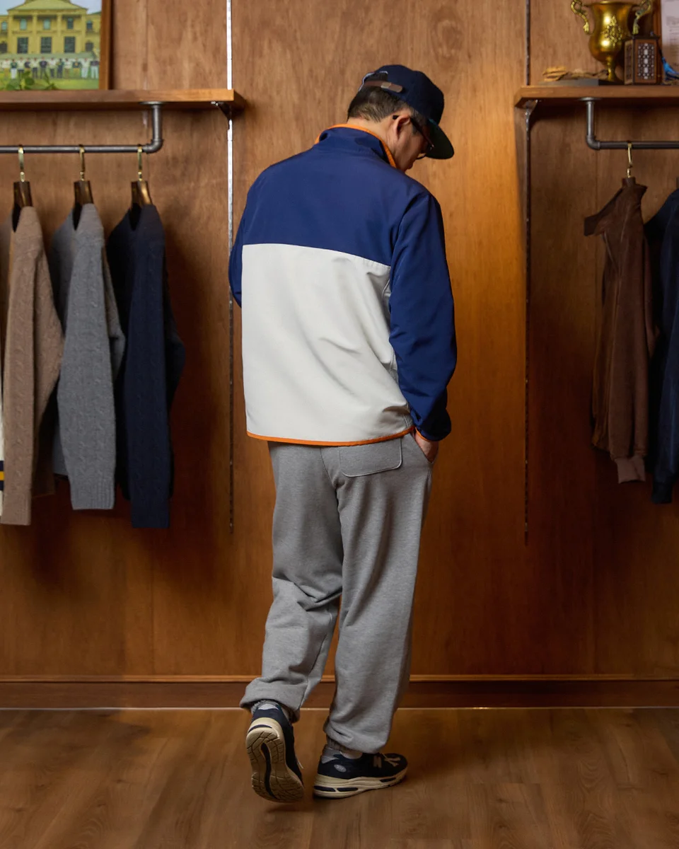 Editorial shot of anorak and oxford shirt combination on a Seoul street