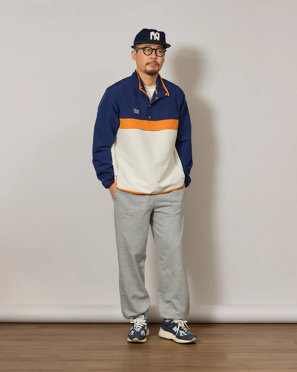 Anorak outfit men spring — Renacts anorak over white tee with sweatpants and New Balance 991v2, ballcap