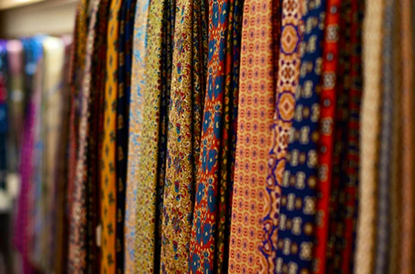Drake's of London history: a tray of Drake's neckties showing the brand's full pattern range — English repps, paisleys, foulards, and madders