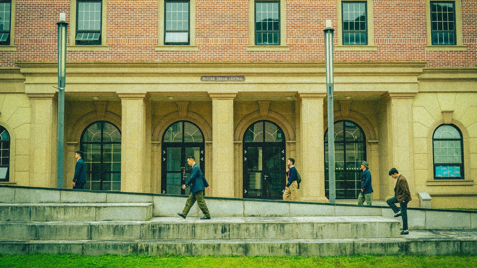 Renacts editorial of layered Seoul outfit with anorak over oxford shirt and tapered chinos