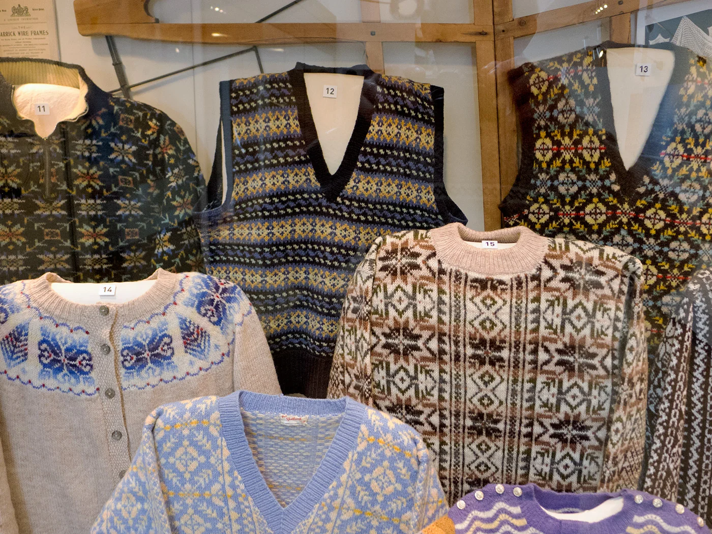 Fair Isle knit history: traditional Fair Isle knitwear displayed at the Shetland Museum, showing the multi-color geometric pattern native to the small Scottish island