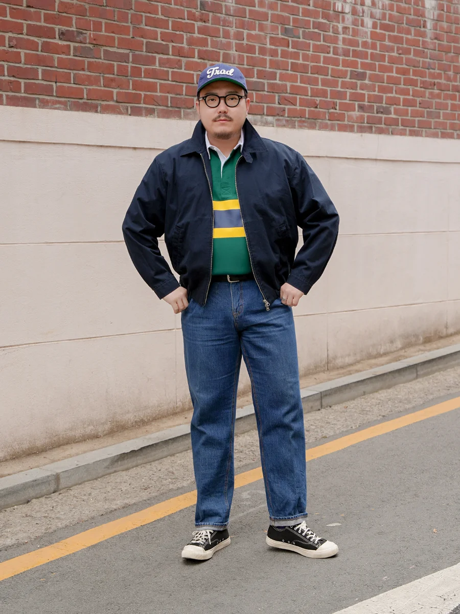 Harrington jacket casual outfit — navy harrington jacket over green rugby shirt with mid-wash denim in Seoul