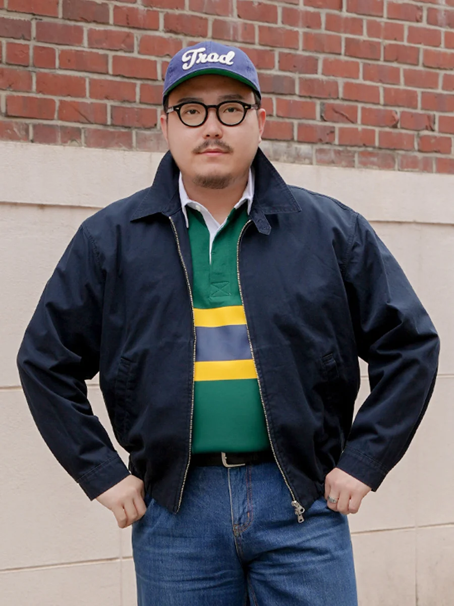 Harrington jacket casual outfit — mid-wash straight-leg denim with black leather belt