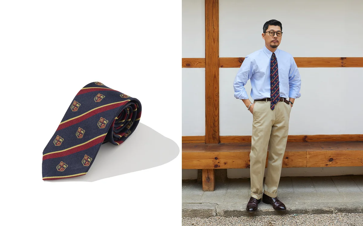 A repp stripe tie in navy and burgundy showing proper 3.25-inch width and wool interlining construction