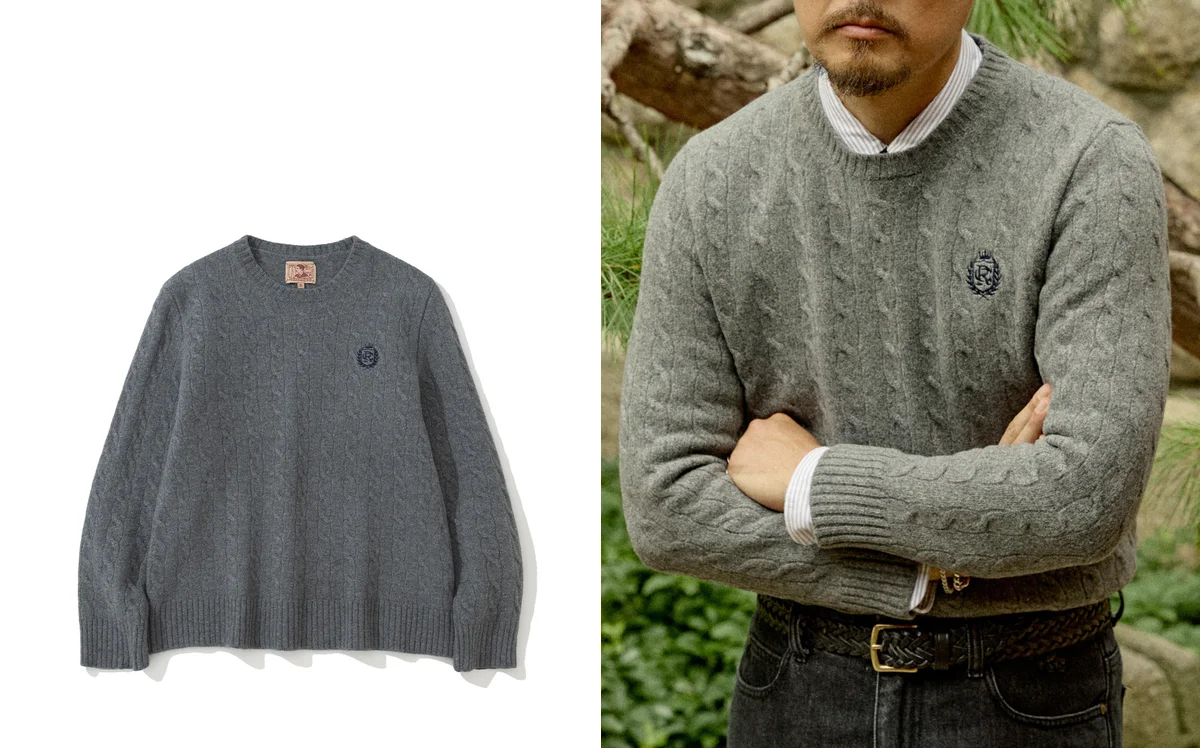 Close-up of lambswool crewneck sweater fabric showing 12-gauge knit texture and ribbed neckband