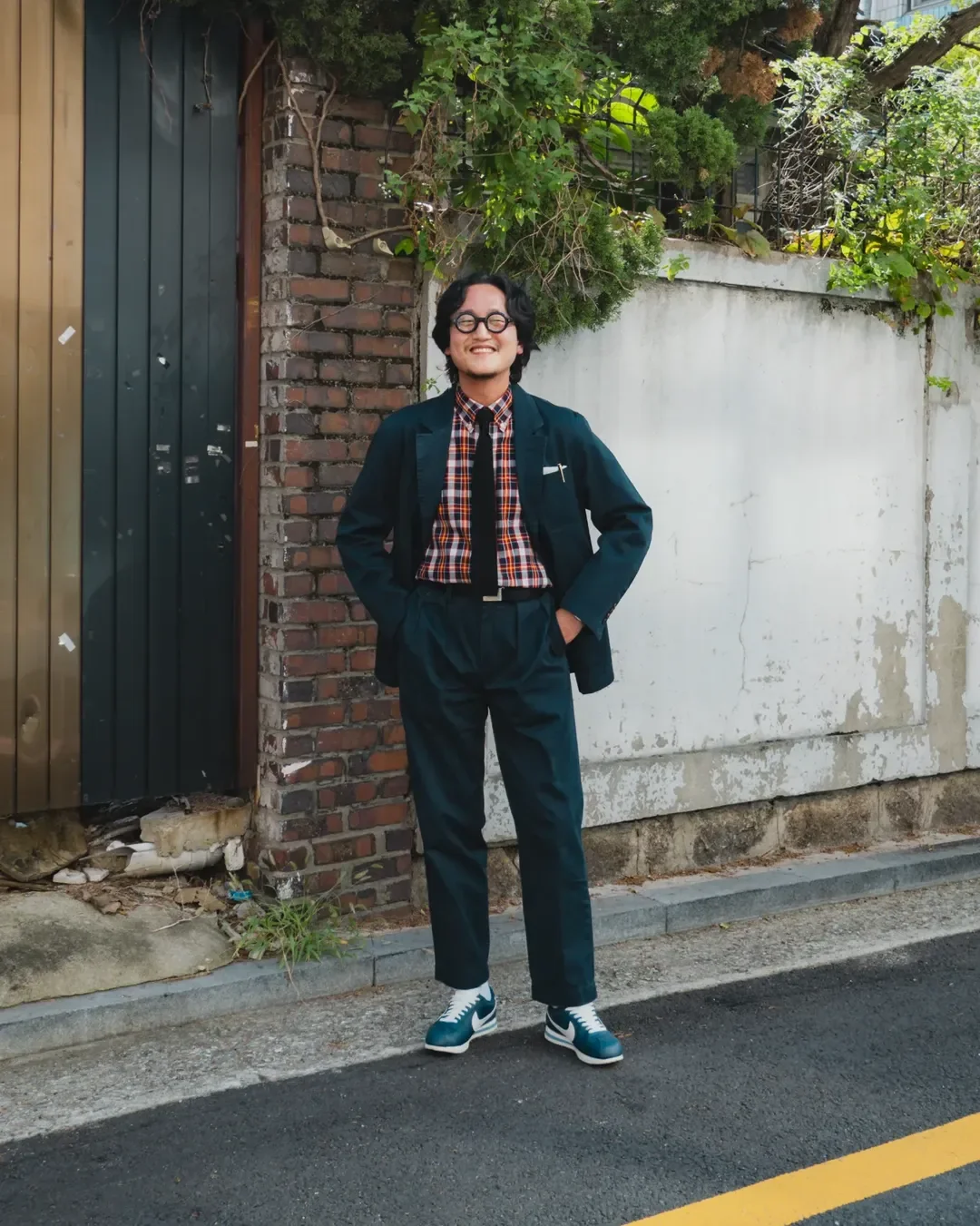 How to wear madras shirt — navy corduroy setup with red madras and blue suede sneakers, Seoul side street