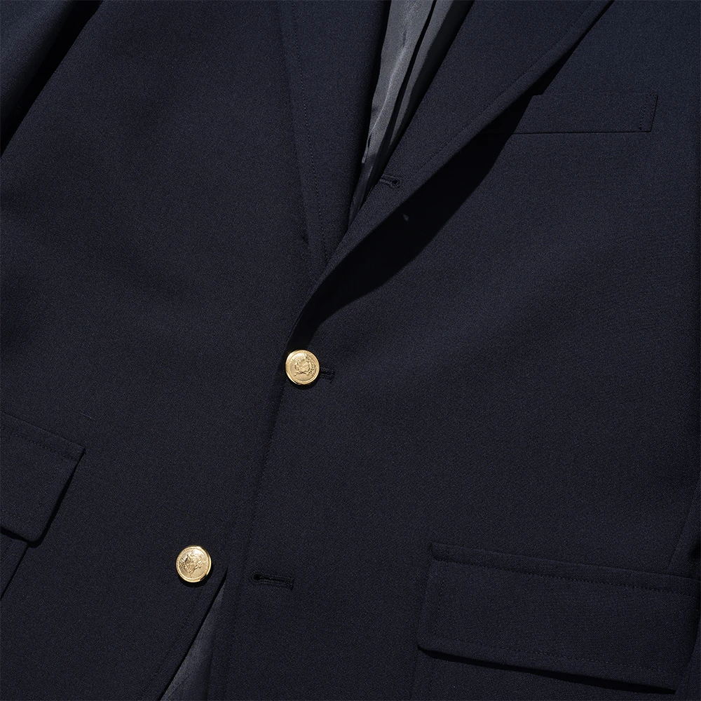 Renacts navy gold-button blazer 3/2 roll position close-up — two visible gold front buttons in the canonical American sack-cut roll, structural top button hidden under the lapel break