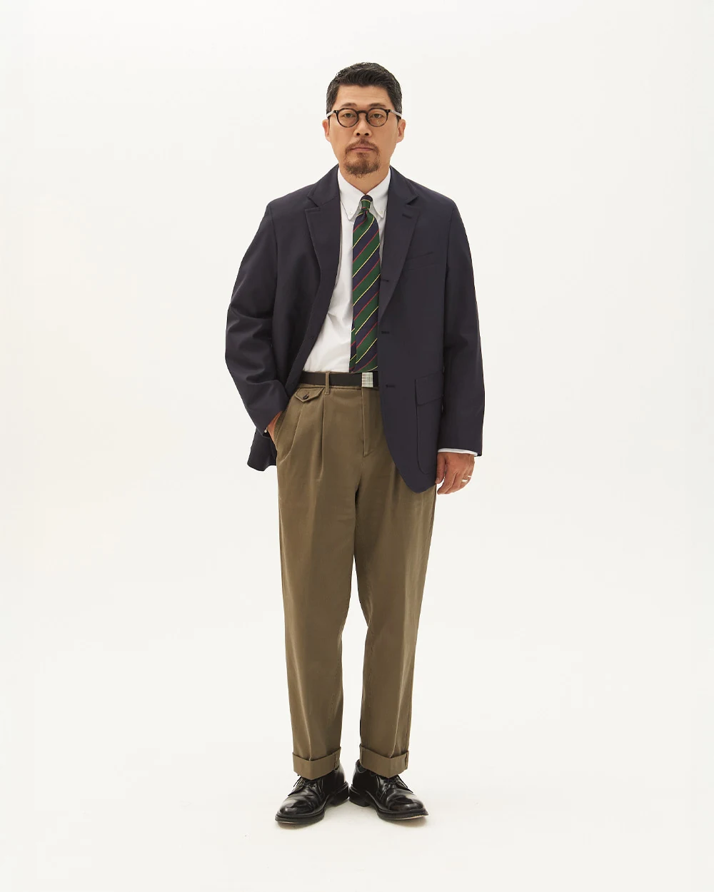 Navy gold-button blazer outfit — single-breasted blazer, white OCBD, regimental rep tie, olive military chinos, plaque belt, black plain-toe derbies