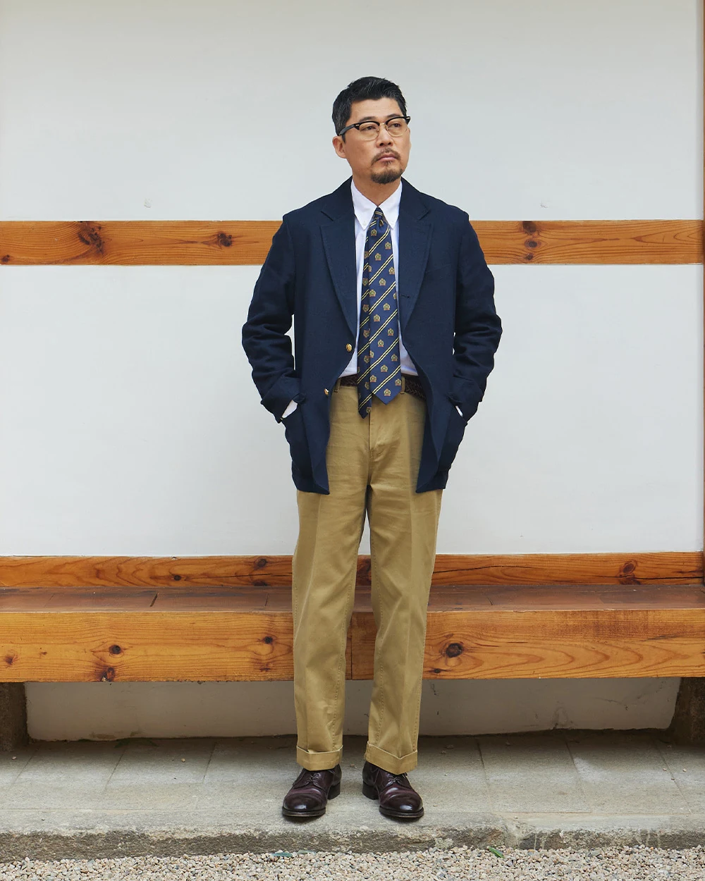 Navy gold-button blazer outfit — single-breasted blazer, white OCBD, regimental rep tie, khaki chinos, plaque belt, burgundy plain-toe derbies, autumn preppy with warm shoe