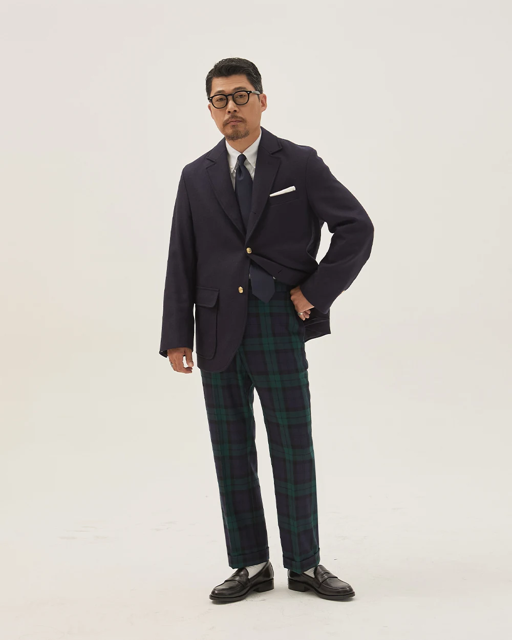 Navy gold-button blazer outfit — single-breasted blazer, white OCBD, black silk knit tie, Blackwatch tartan wool slacks, plaque belt, black penny loafers, holiday and seasonal evening configuration