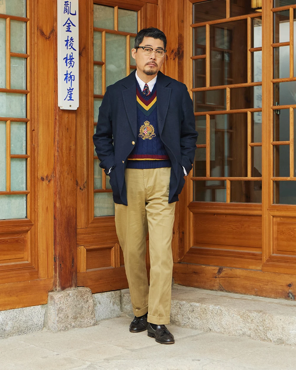 Navy gold-button blazer outfit with cricket sweater vest — same as G1 but with black tassel loafers replacing penny loafers