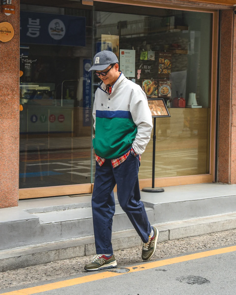 Navy chino pants outfit — anorak and madras layered street style in Seoul