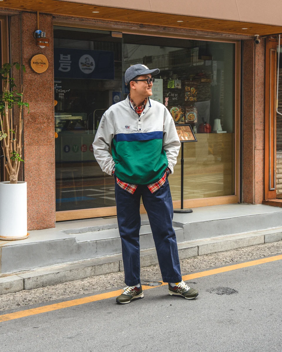 Navy chino pants outfit — New Balance 997 Aimé Leon Dore sneakers with chinos and anorak