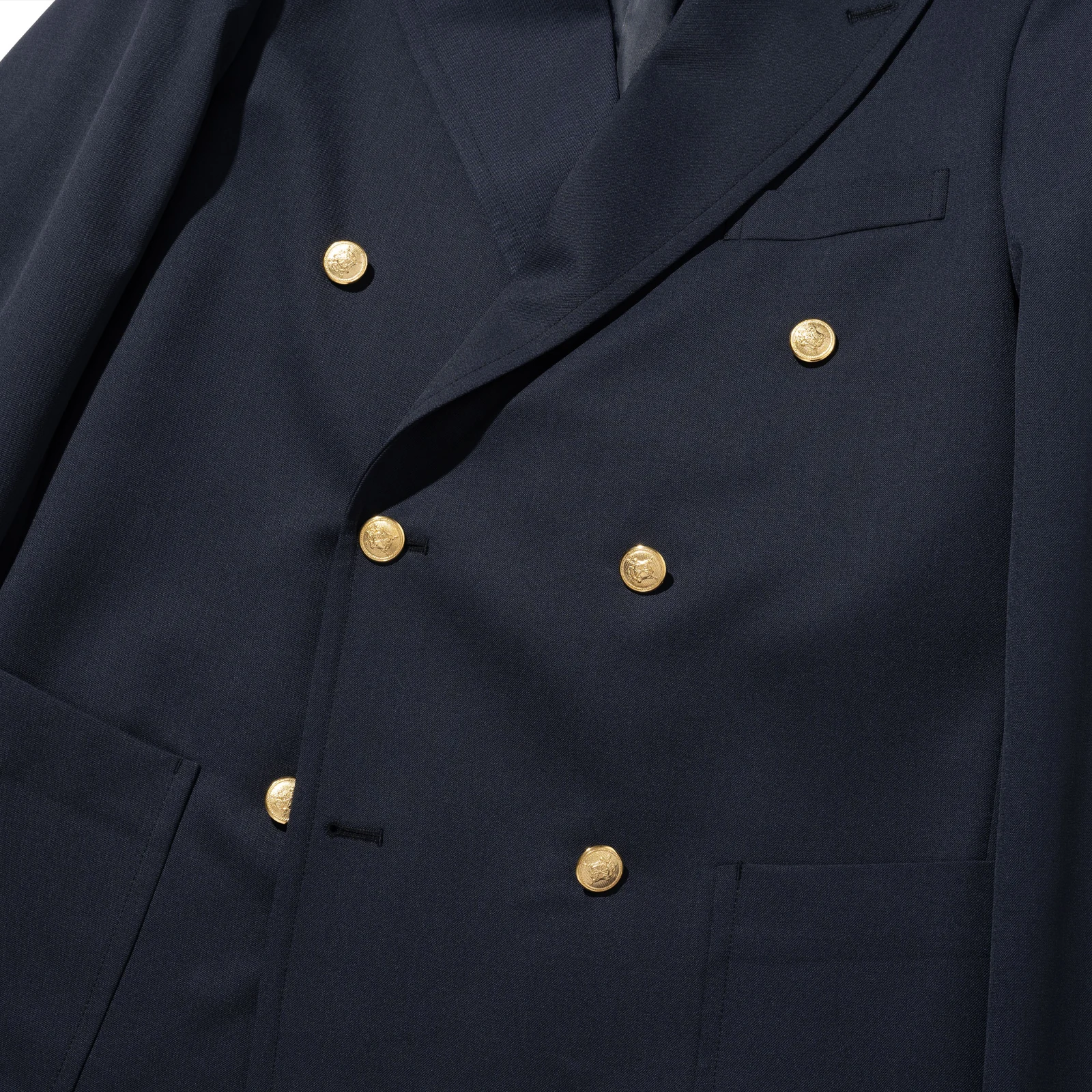 Renacts navy gold-button double blazer six-button arrangement detail — three rows of two gold buttons in classic 6×2 double-breasted pattern