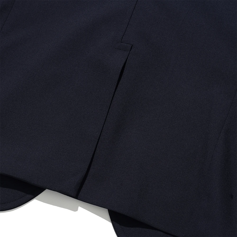 Renacts navy gold-button blazer hook vent detail — single rear vent at the hem, characteristic American Ivy detail
