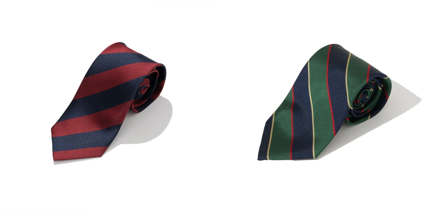 Renacts repp tie pair: two-tone red and navy regimental silk rep tie alongside a green-navy regimental crest silk rep tie — 100% silk, 149cm length and 8cm blade, the Seoul-made parallel to Drake's English repp