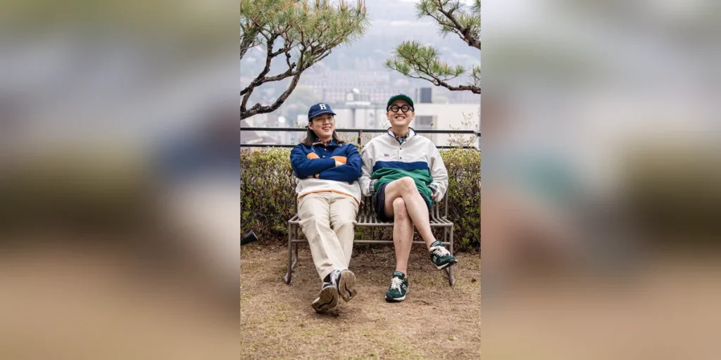 Anorak outfit men spring — featured thumbnail, navy and green Renacts New Trad Anorak Pullovers on a Seoul bench