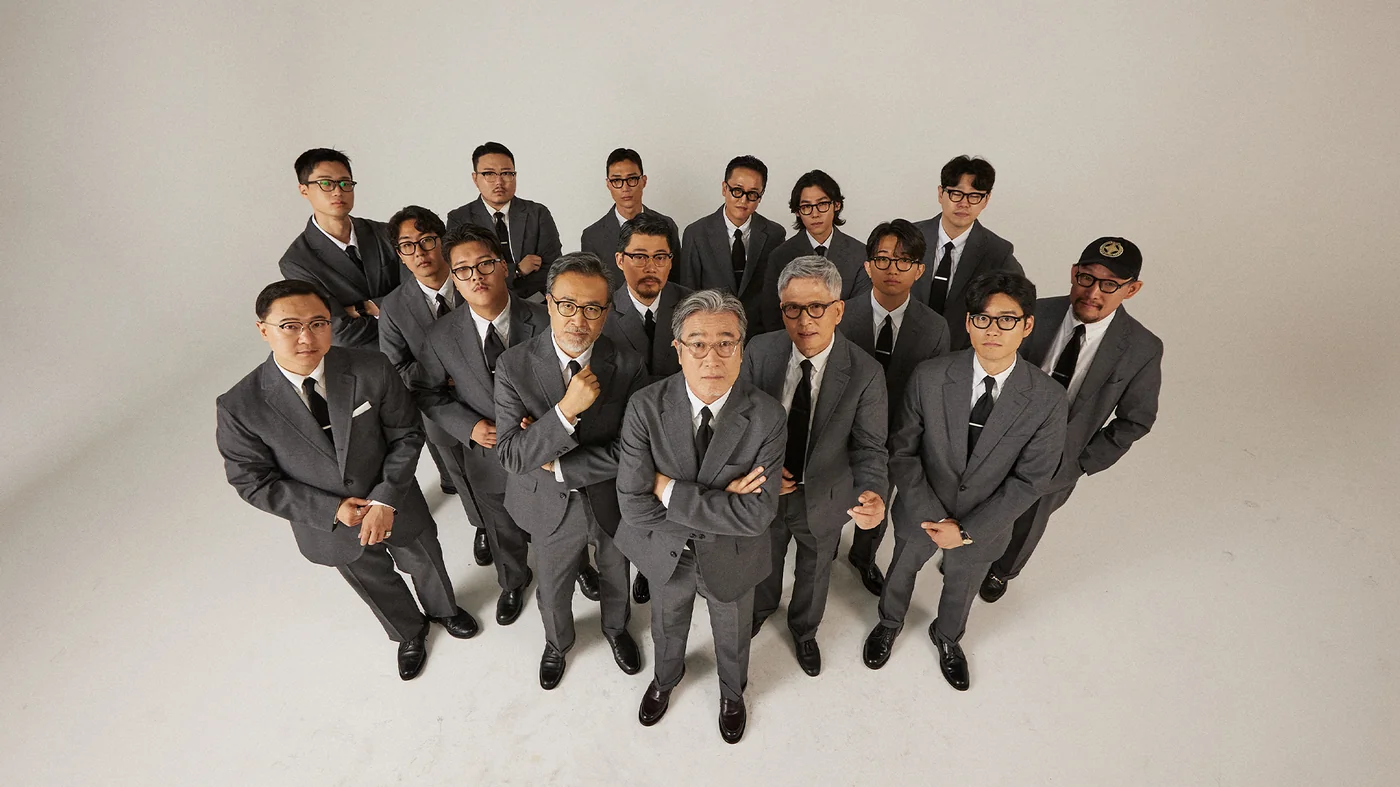 Yale Ivy style continuation — the full Renacts team photographed in the grey sack suit legacy shot, the Yale-to-Seoul sack-cut vocabulary reassembled at scale