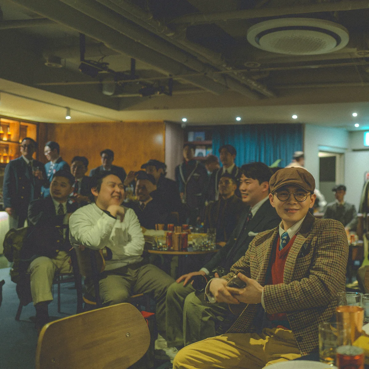 Members of Gentlemen's Club Vol. 6 in close-up — hunting cap, tweed, blazers, and Shetland sweaters