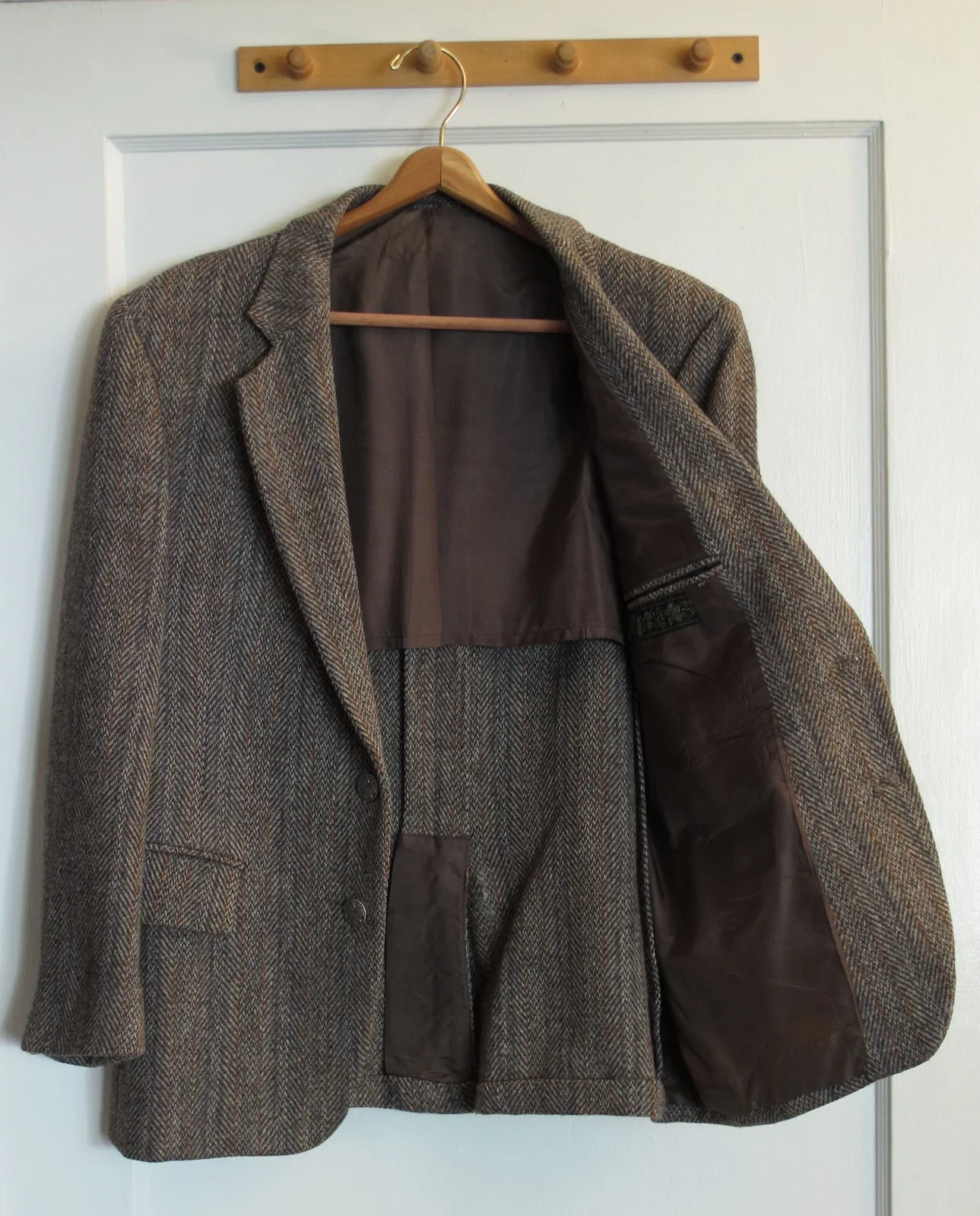 sport coat essentials hero: tailored grey sport coat with patch pockets and partial interior lining showing classic construction