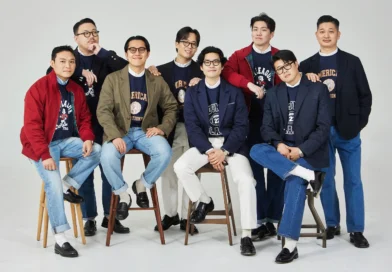 trad denim worn as a set: Renacts team in blazers and jackets layered over collegiate sweatshirts, with seven different denim shades visible across the group