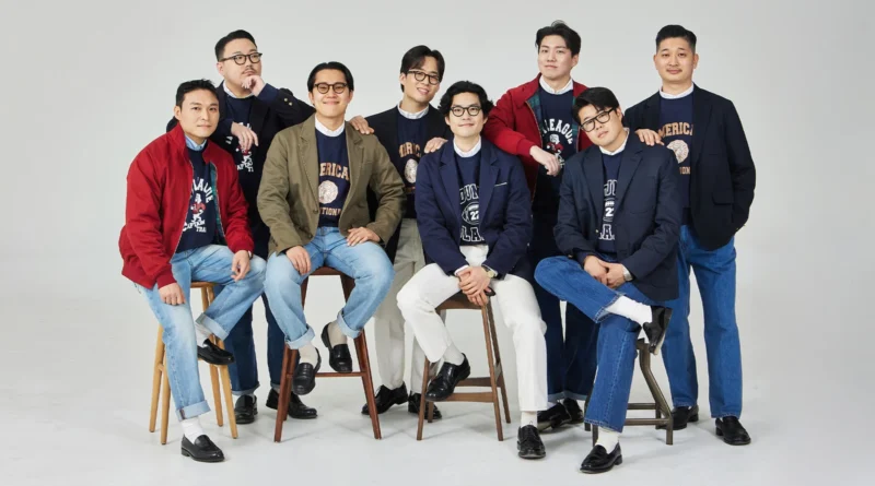 trad denim worn as a set: Renacts team in blazers and jackets layered over collegiate sweatshirts, with seven different denim shades visible across the group