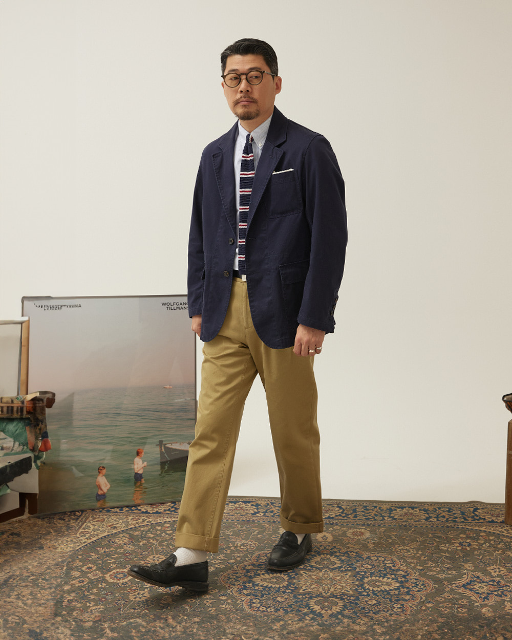 Khaki chinos with a navy blazer, knit tie and penny loafers — ivy style khaki chinos