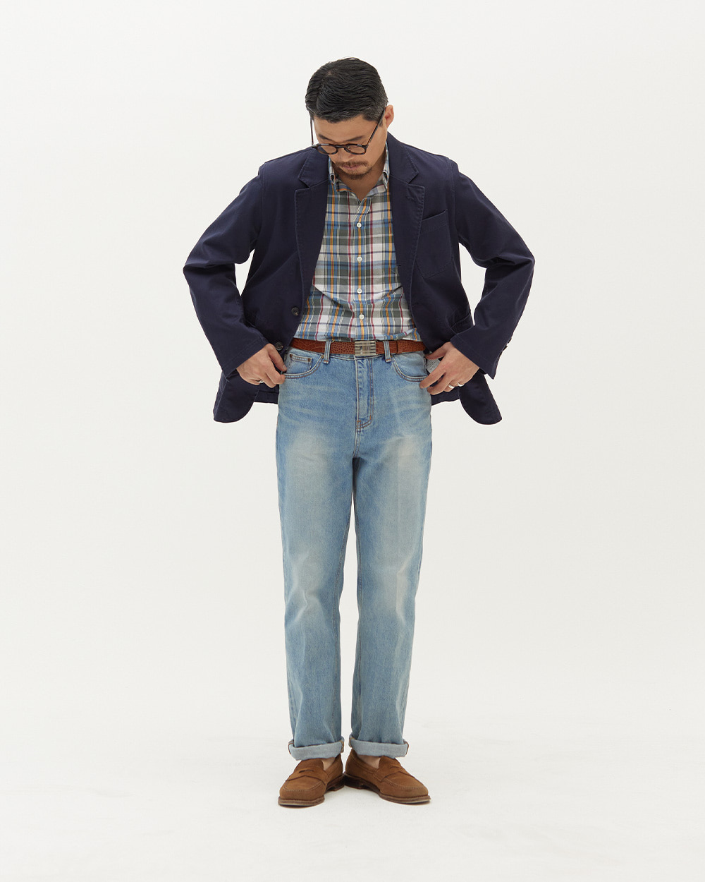 Unstructured navy cotton blazer with a natural shoulder worn over a madras shirt — the ivy sack blazer